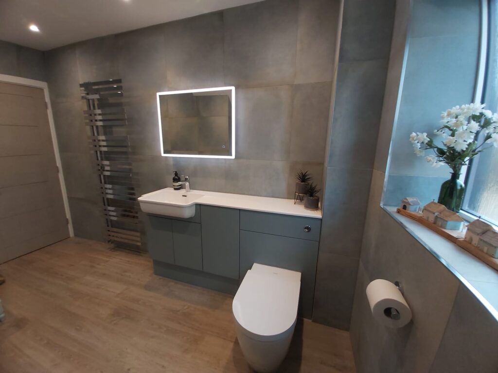 One-piece basin and worktop with Fjord Blue fitted bathroom furniture in luxury bathroom
