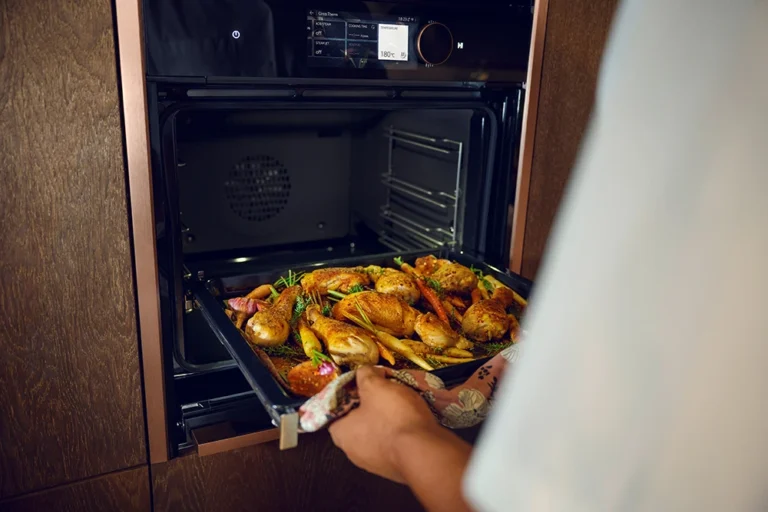 Person putting food into the Neff oven.