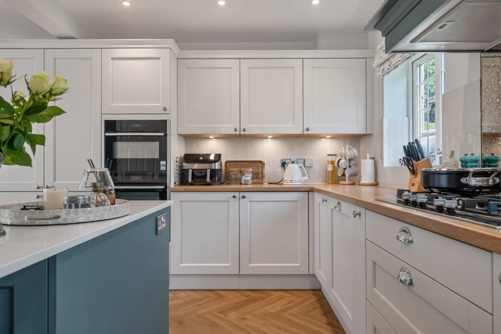 Masterclass kitchen with built-in NEFF ovens, Duropal Natural Oak Block laminate worktops, under-cabinet lighting and a gas hob.